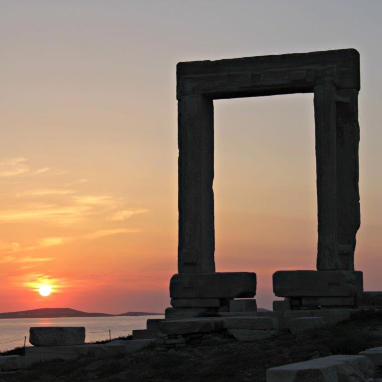 Why these are 3 of Our Favorite Travel Destinations - Portara at Sunset www.compassandfork.com